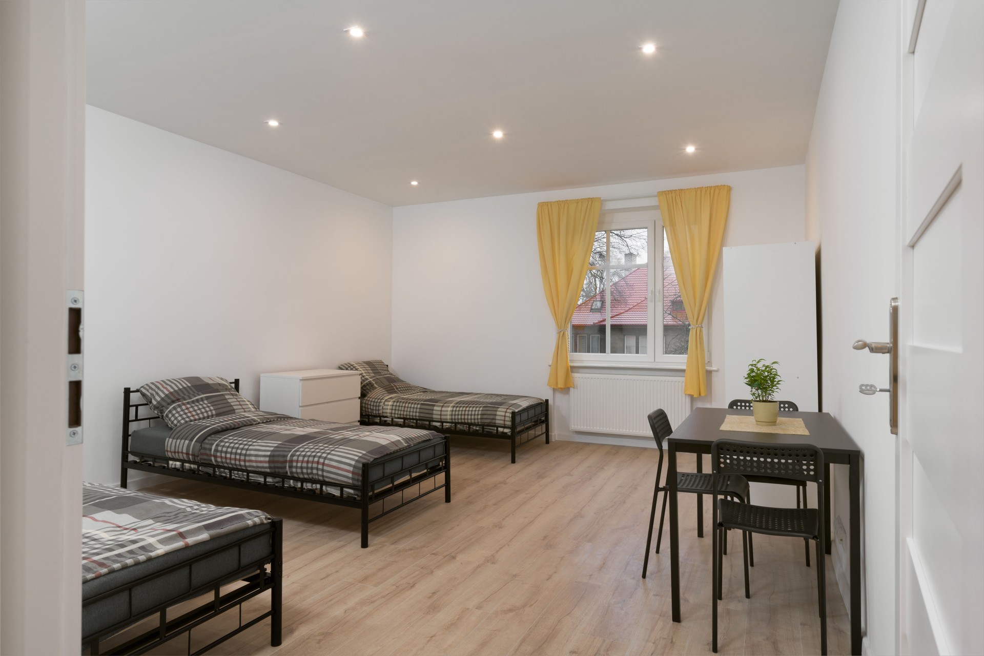 Simple Furnished Dorm Room with Multiple Beds