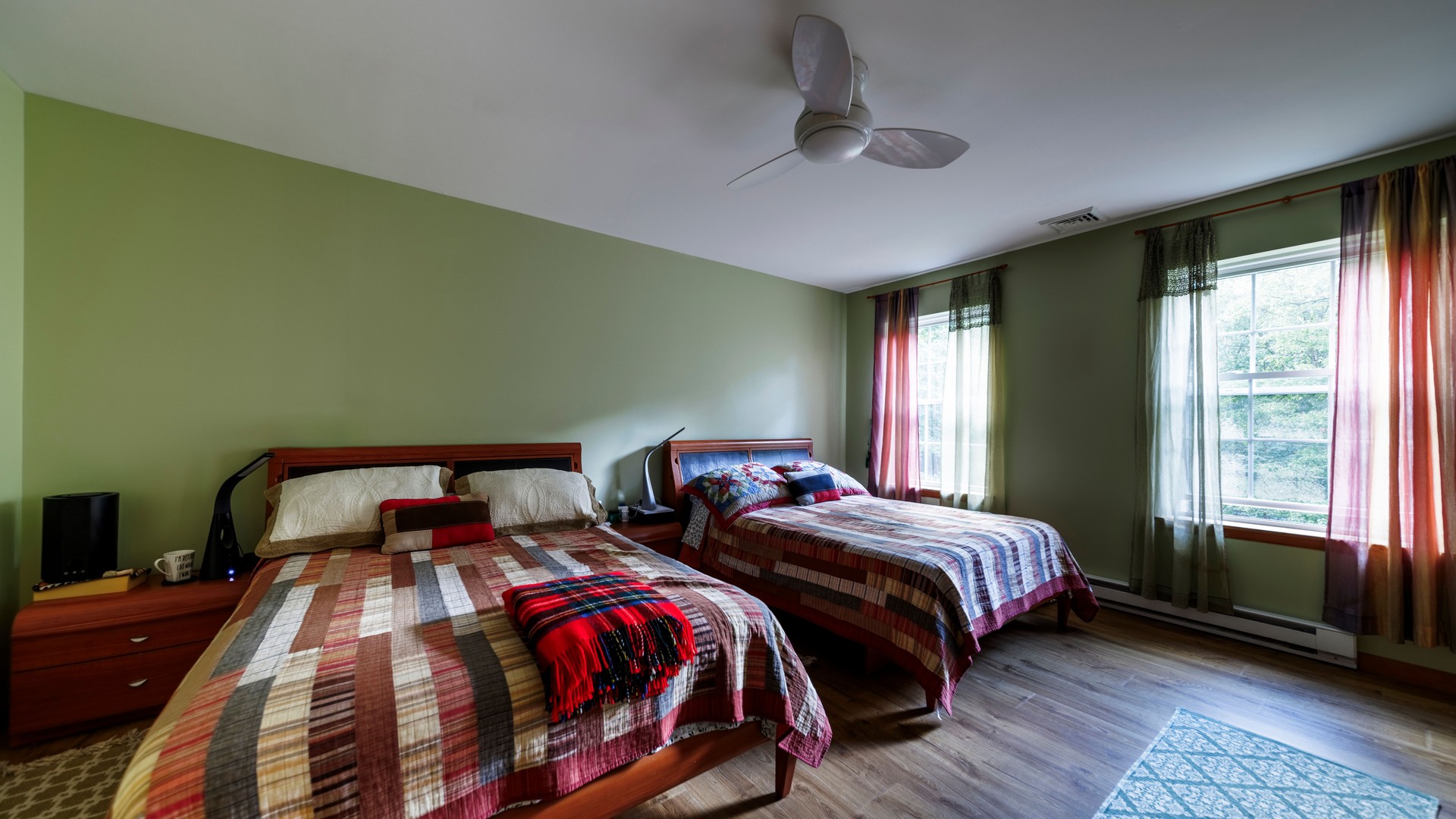 Relaxing in Poconos vacation home. Spacious shared bedroom offers comfort for families or friends.